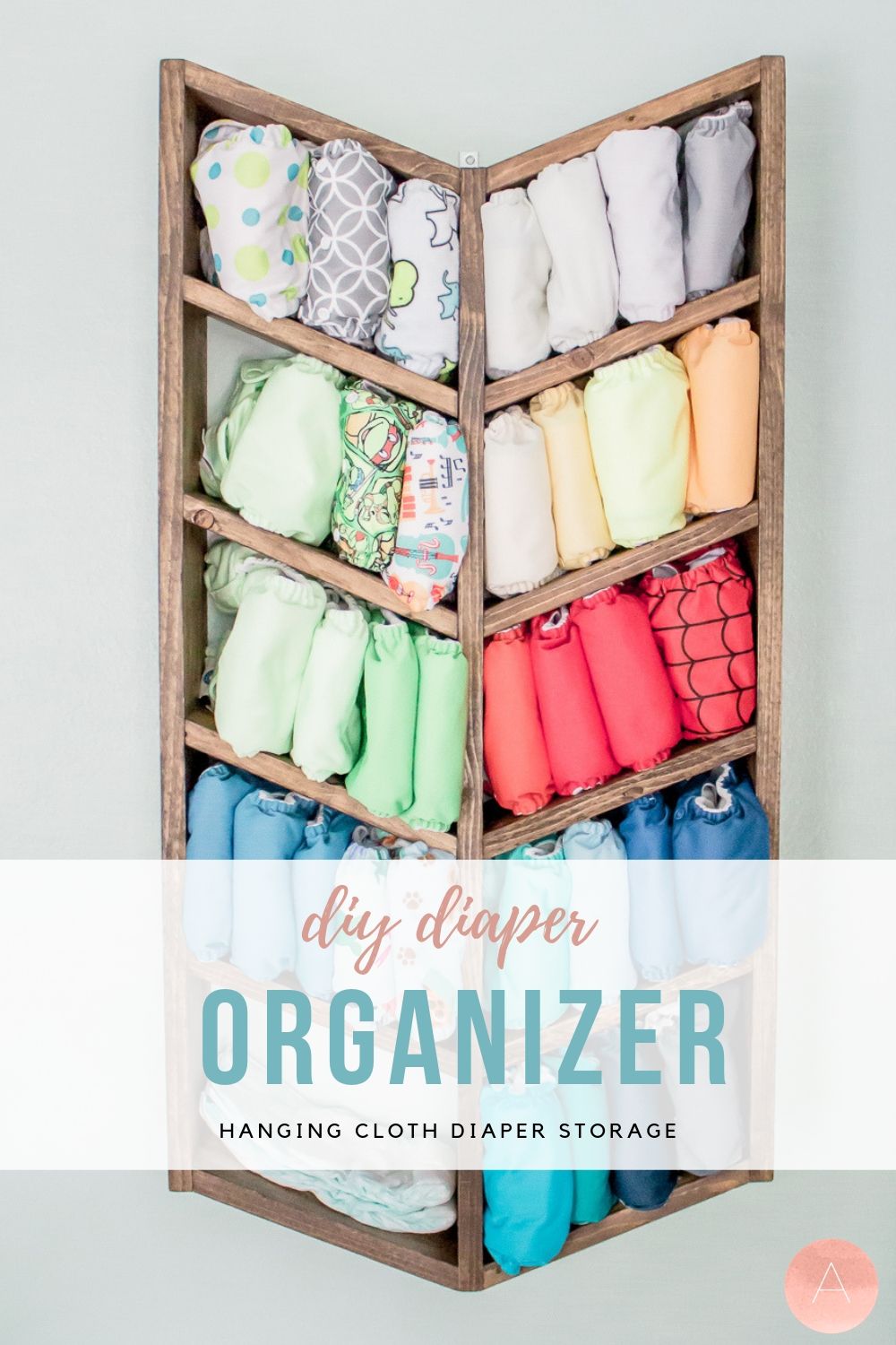 Love using cloth diapers, but hate how much space they take up? Make hanging storage for your cloth diapers! This DIY solution is unique, adorable, versatile, and super practical. Find out how to make it with this free pattern! #clothdiapers #babynursery #nurserydesign #homestorage #organized #diykids